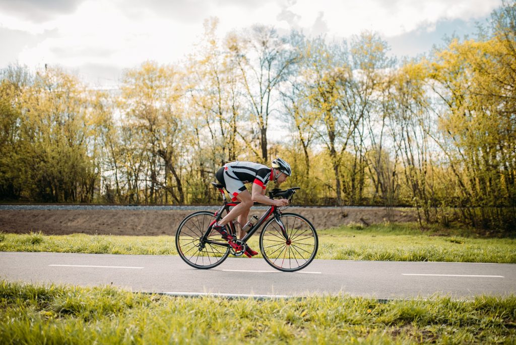 man cycling on road